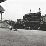 Wrigley gum Doublemint elves dance atop the leftfield scoreboard in 1937